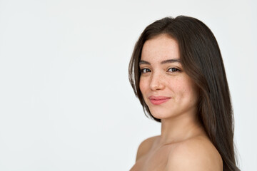 Smiling brunette Latin girl, happy pretty young adult woman with freckles on face looking at camera isolated on white background. Skincare, hair care cosmetic for young skin, beauty close up portrait.