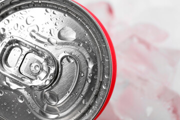 Energy drink in wet can on light background, closeup. Space for text