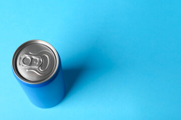 Energy drink in can on light blue background, above view. Space for text