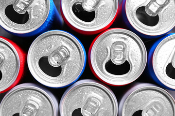 Energy drinks in wet cans as background, top view. Functional beverage