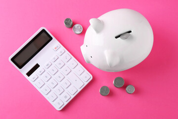 Financial savings. Piggy bank, coins and calculator on pink background, flat lay