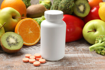 Dietary supplements. Plastic bottle, pills and food products on wooden table