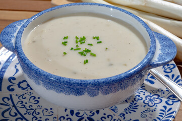 Bowl of homemade cream soup from white asparagus, spring season, new harvest of Dutch, German white asparagus, cooking with asparagus