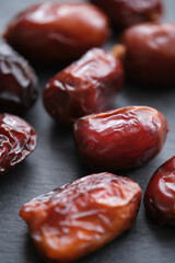 Dried dates are laid out slate board.
