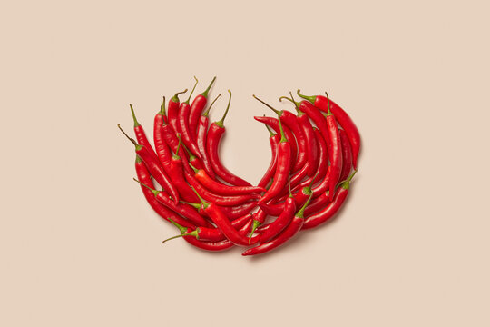 Organic fresh chili peppers arranged on pastel background