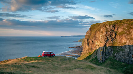 landscape of a cliff, with the sea in the background, on the cliff is parked a camper van, - obrazy, fototapety, plakaty