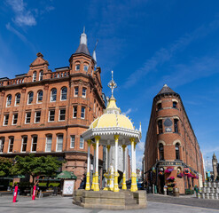 exterior facade of Bittles Bar next to The Jaffe Memorial Fountain located in Victoria Square, the shopping center and the flatiron and the Albert Memorial Clock, Belfast, Northern Ireland. - obrazy, fototapety, plakaty