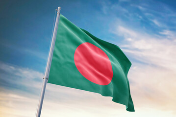 Waving flag of Bangladesh in blue sky. Bangladesh flag for independence day. The symbol of the state on wavy fabric.