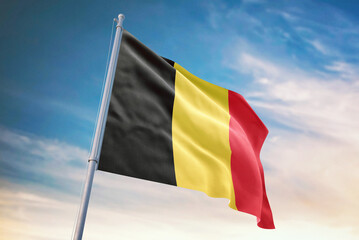 Waving flag of Belgium in blue sky. Belgium flag for independence day. The symbol of the state on wavy fabric.