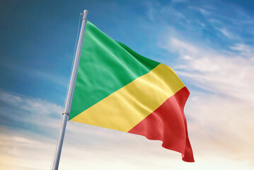 Waving flag of Congo in blue sky. Congo flag for independence day. The symbol of the state on wavy fabric.