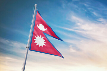 Waving flag of Nepal in blue sky. Nepal flag for independence day. The symbol of the state on wavy fabric.