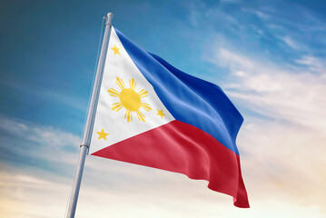 Waving flag of Philippines in blue sky. Philippines flag for independence day. The symbol of the state on wavy fabric.