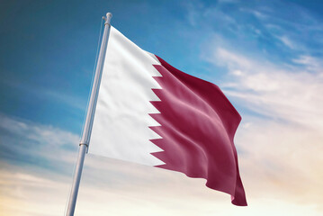 Waving flag of Qatar in blue sky. Qatar flag for independence day. The symbol of the state on wavy fabric.