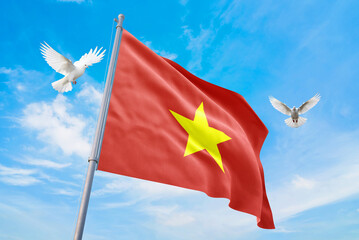Waving flag of Vietnam in beautiful sky and flying pigeons. Vietnam flag for independence day. The symbol of the state on wavy fabric.