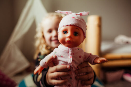 Girls shows off baby doll.