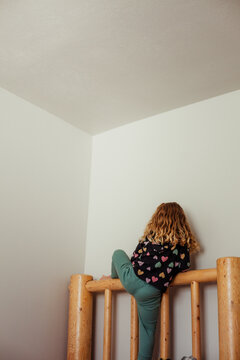 Climbing the bedframe with corner near.