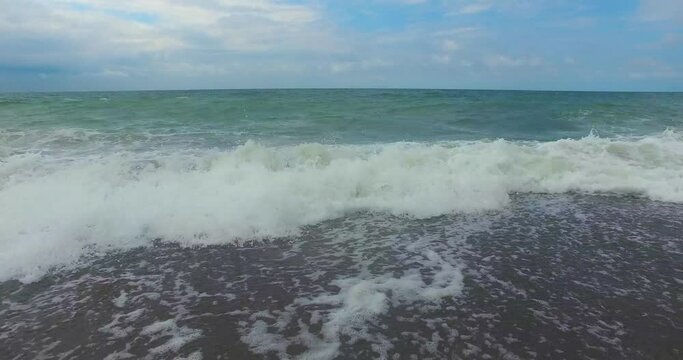 The sea waves gently play with the wind