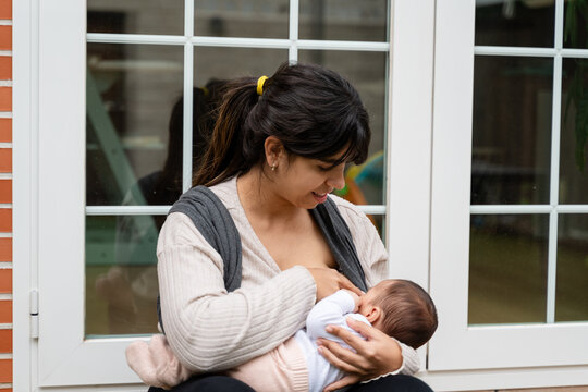 mother breastfeeding a little newborn