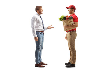 Man talking to a delivery man with a grocery bag