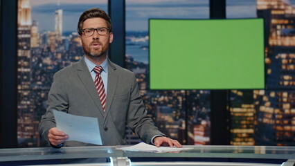 Breaking news reporter talking in front chroma key monitor tv studio closeup
