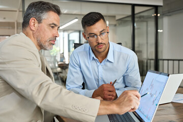 Two busy business men investors doing financial trading market data analysis. Male advisor and...