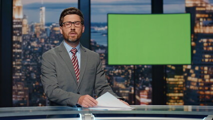 Broadcast presenter reporting daily news at television channel with green screen