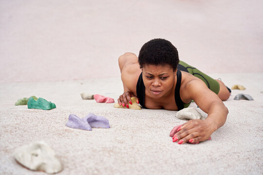 Female Climber Descending Artificial Wall