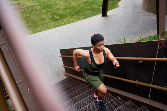 Young Woman Working Out In An Outdoor Space