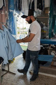 Man Buttons Ironed Blue Shirt.