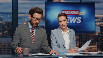Confident hosts presenting news evening television closeup. Presenters reporting