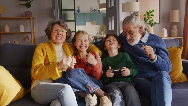 Old couple babysitting kids and using console for having fun
