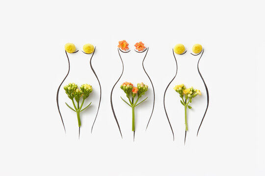 Line sketch of three female figures with natural flowers