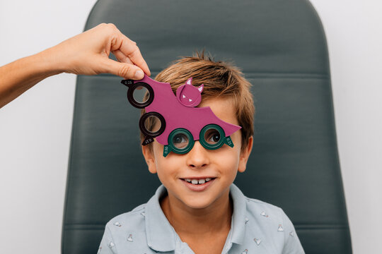 Happy child and anonymous person hand with flipper lens measure