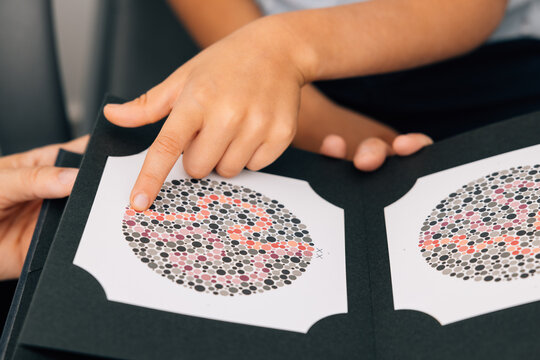 Crop child undergoing color blindness test in clinic - Powered by Adobe