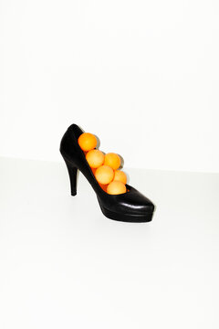 Classic black leather high heel neon orange ping pong balls inside