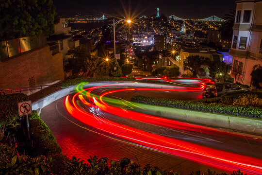 Light trails of a car down a windy street.