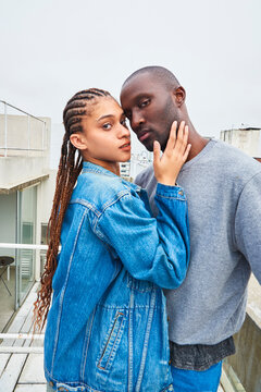 Multiracial Young Couple On A Terrace.