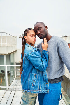 A multiracial couple on a terrace.