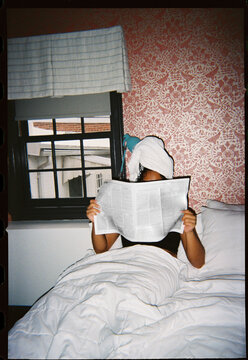 Reading Newspaper in Bed