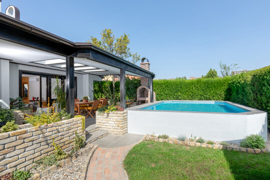 Landscaped house backyard with a swimming pool