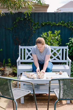 Girl braiding garlic for storing