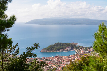 Idyllic hiking trail along coastline of Makarska Riviera in coastal village Kotisina, Split-Dalmatia, Croatia, Europe. Panoramic vista of mountain ridges in Biokovo nature park, Dinaric Alps, Balkan