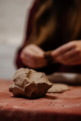 A fresh lump of clay lies in pottery workshop