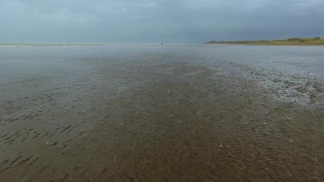 Rain falling gently on the beach. 4k footage.