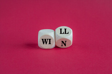 Turned a cube and changes words will to win. Beautiful pink background. Business, motivational and we will win concept. Copy space.