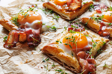 Puff pastry egg and bacon mini tarts  sprinkle fresh cress focus on the tart in middle, close up...