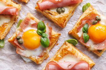 Puff pastry egg and ham mini tarts, close up view. Delicious breakfast or Easter snack - 759167305
