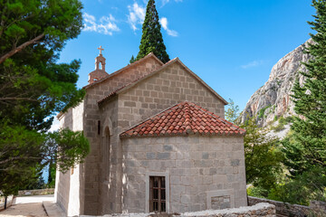 Scenic view of ancient catholic church of St. Anthony in village Kotisina near Makarska, Split-Dalmatia, Croatia, Europe. Hiking in Biokovo nature park in mountain of Dinaric Alps, Balkan. Tourism
