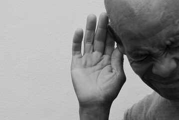 deaf man suffering from deafness and hearing loss on grey background with people stock photo	