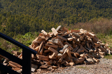 A pile of chopped wood in the courtyard of the dwelling.